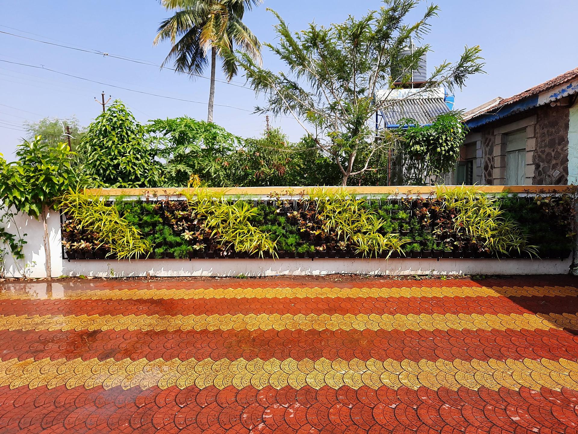 The planted wall running the length of the family courtyard
